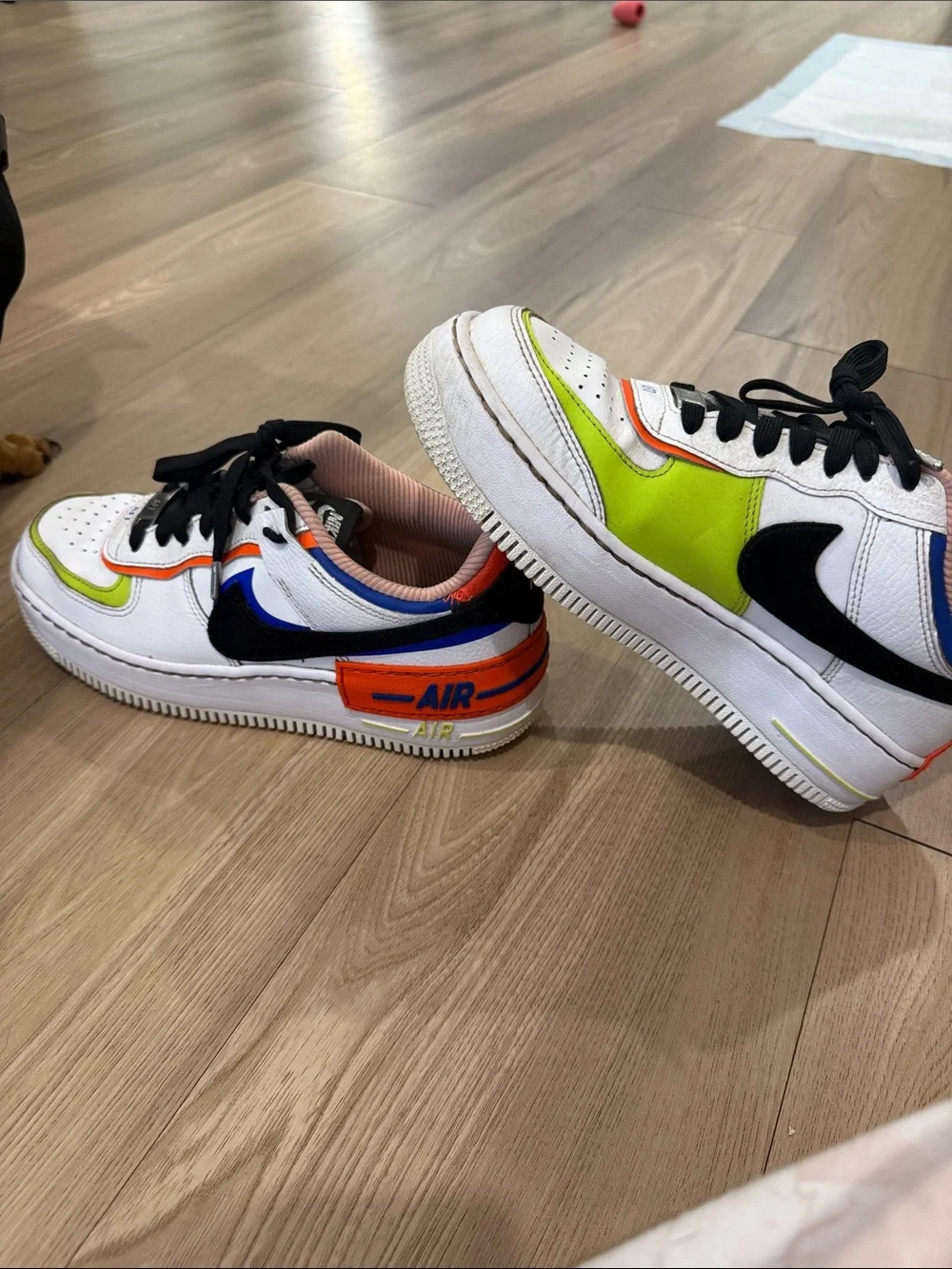 Nike White Low-Top Sneakers with Black Swoosh and Neon Green & Orange Accents